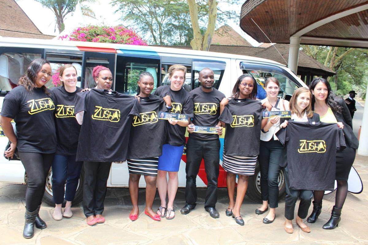 Group posing with research project shirts