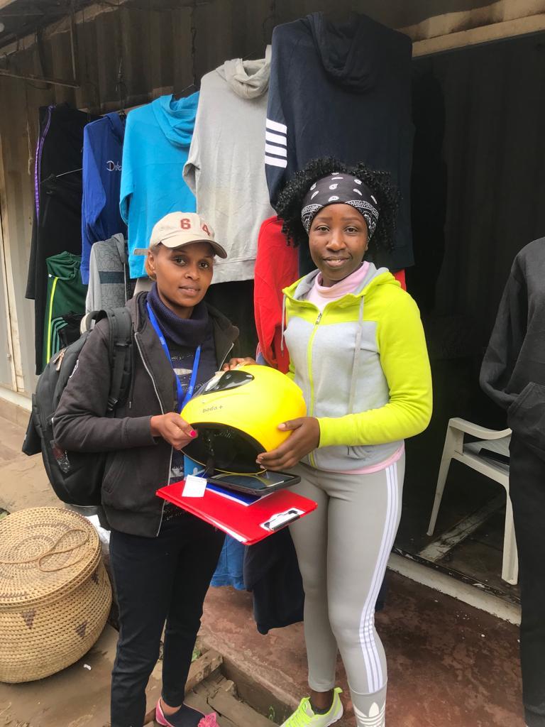 Person passing off a motorcycle helmet to another person
